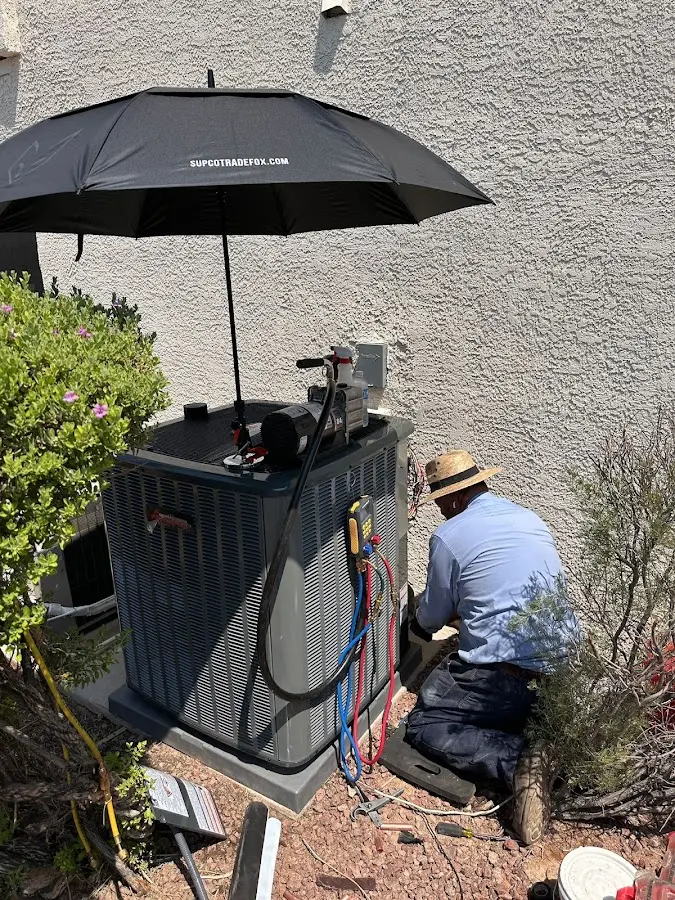 HVAC technician performing outdoor AC maintenance in Lincolnwood